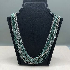 Multi chain mixed metal color link trendy layered statement style necklace.